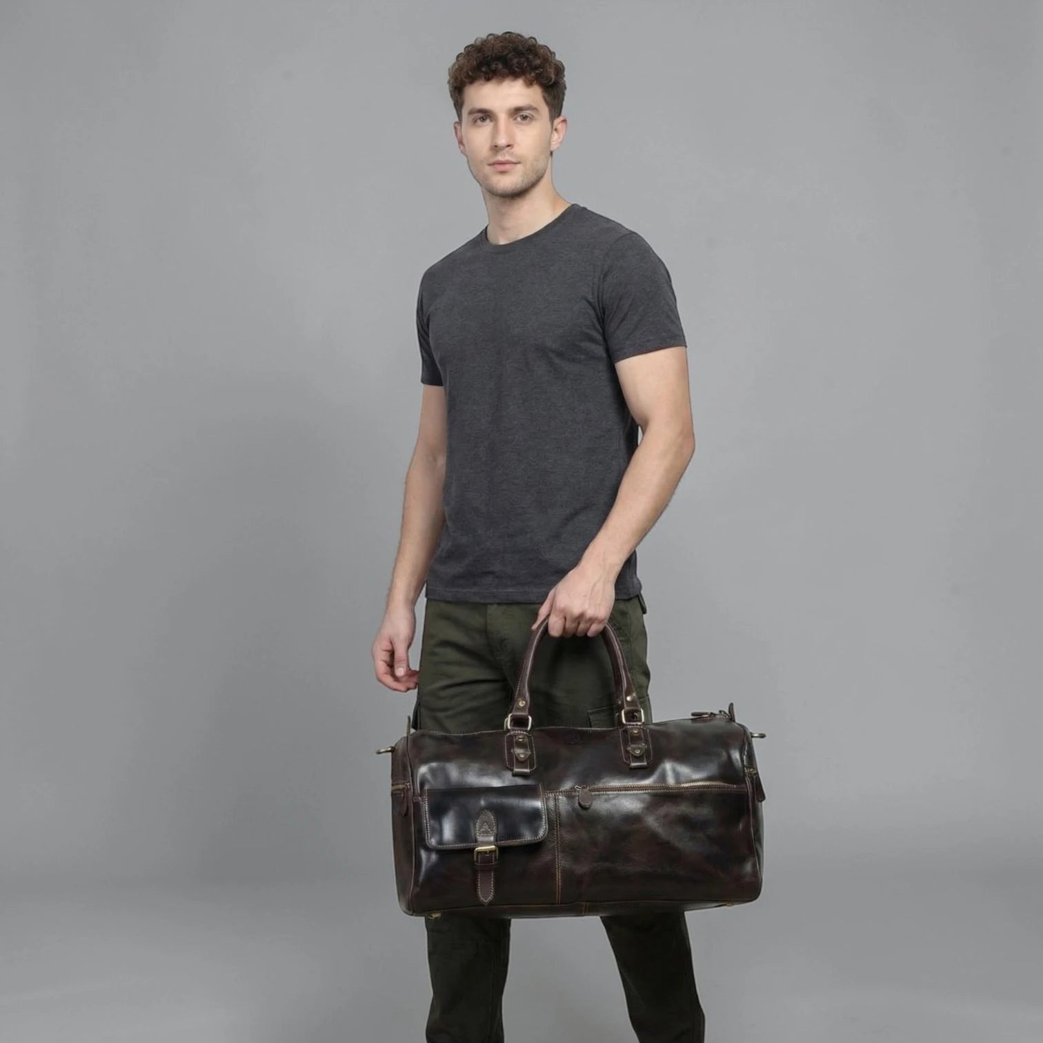 Man holding The Odyssey Leather Travel Duffle in Espresso Brown